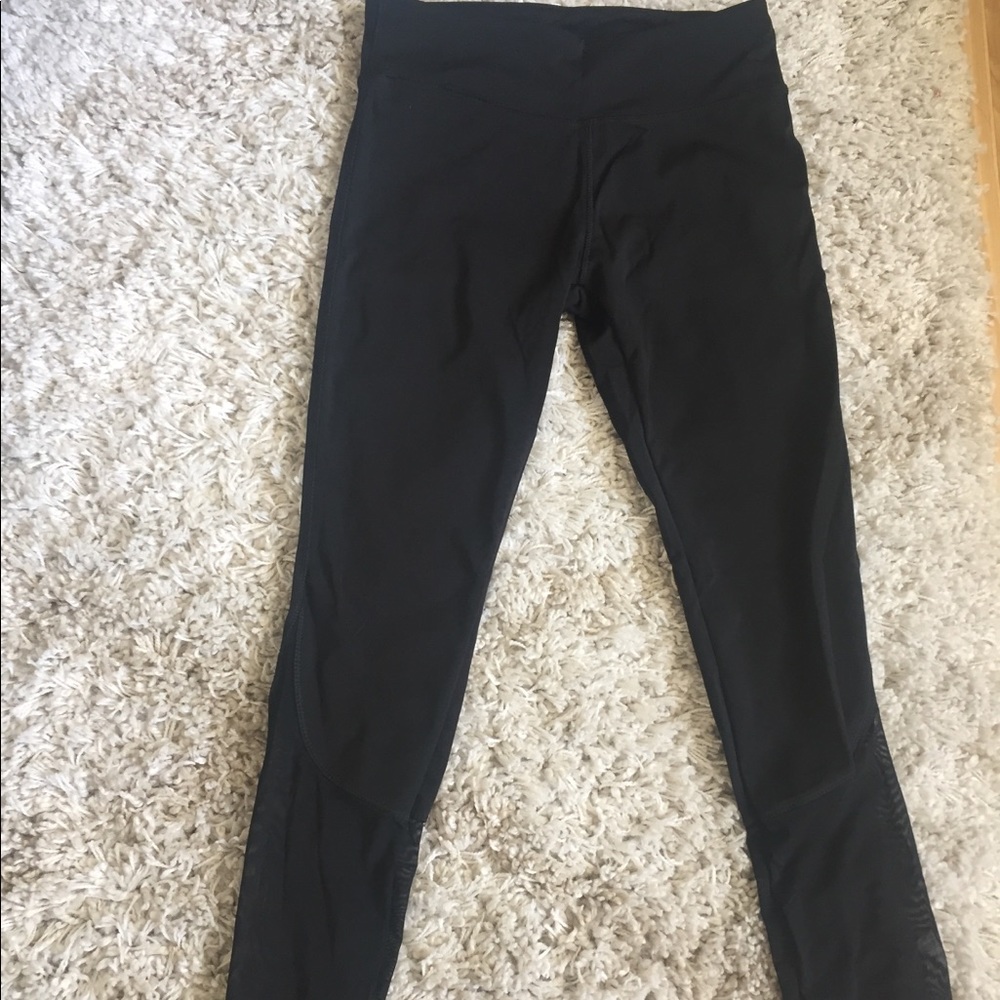 black leggings with mesh bottoms.